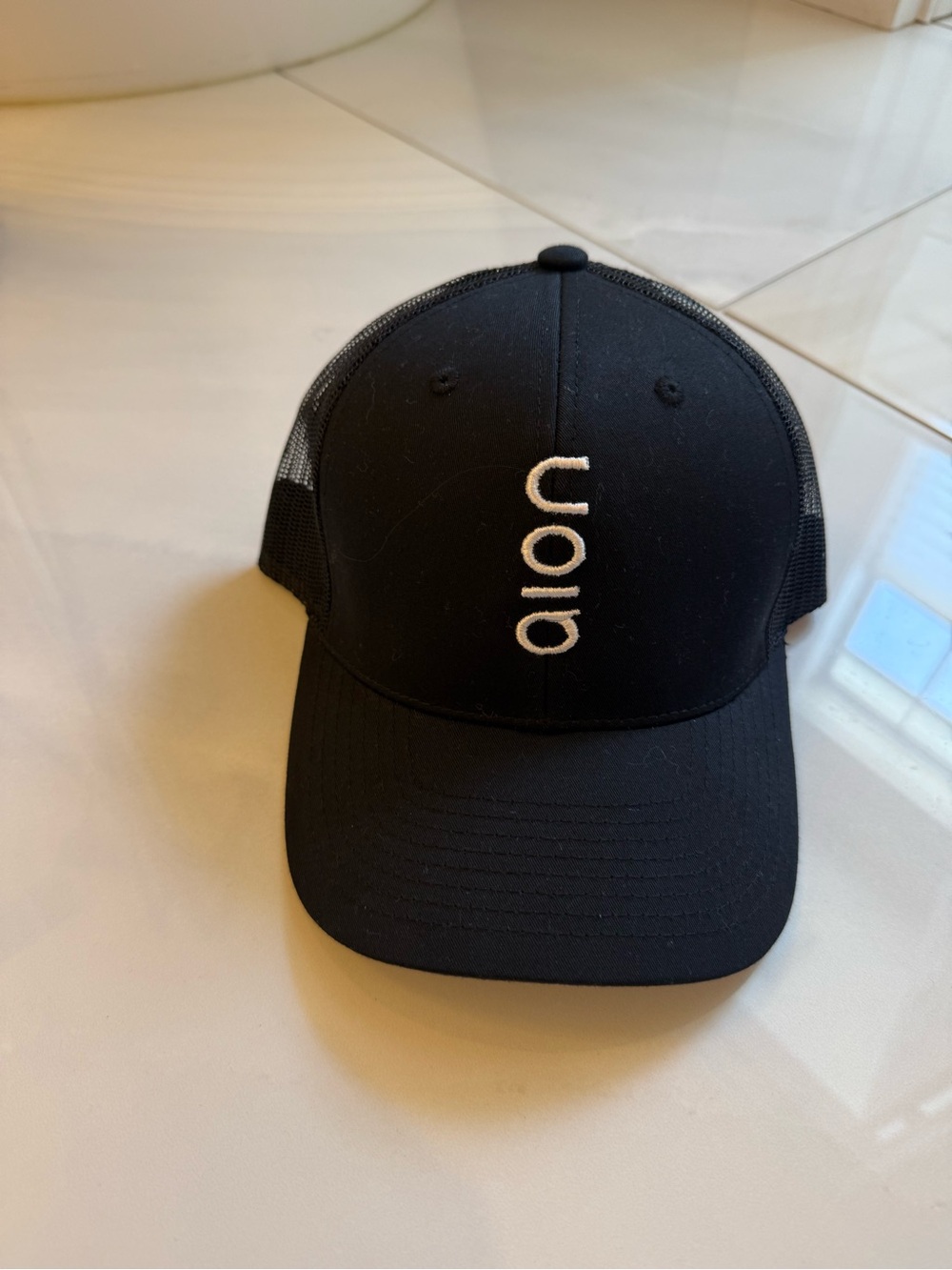 Black Trucker Hat with White Vertical Logo